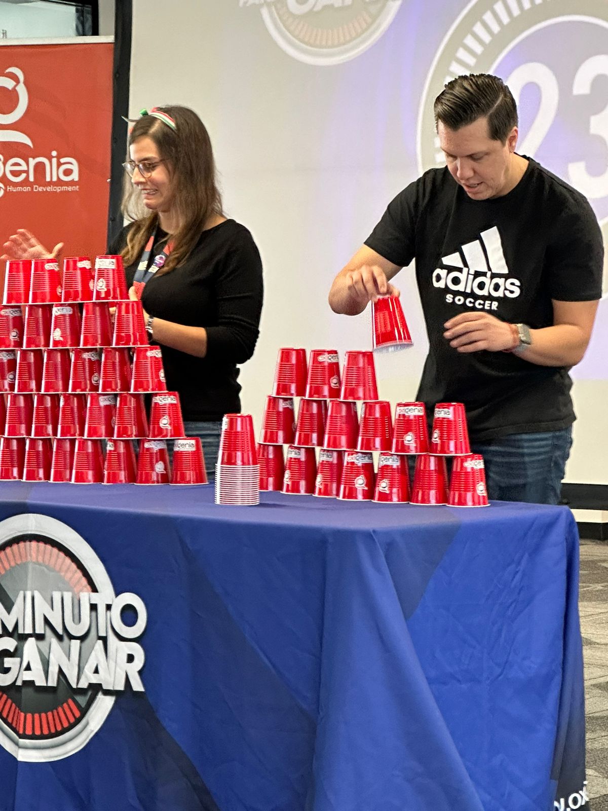 F5ers Ana Claudia Quevedo and Alan David Gomez stack as many paper cups as part of a team building exercise during Hispanic Heritage Month.